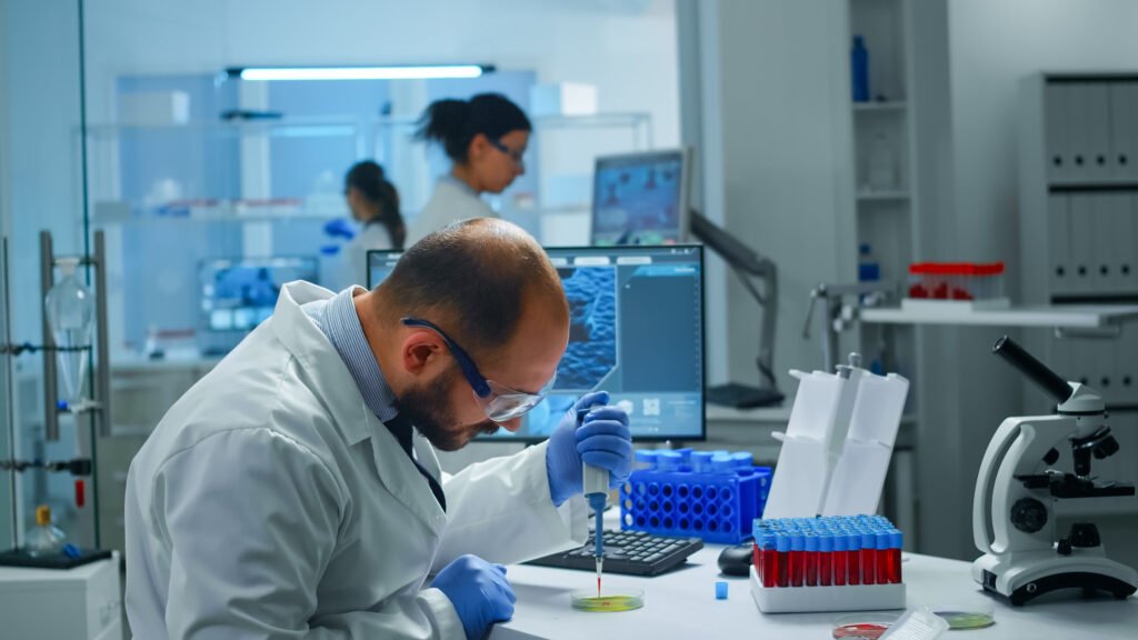scientist examining drug discovery putting blood sample in petri dish with micropipette.